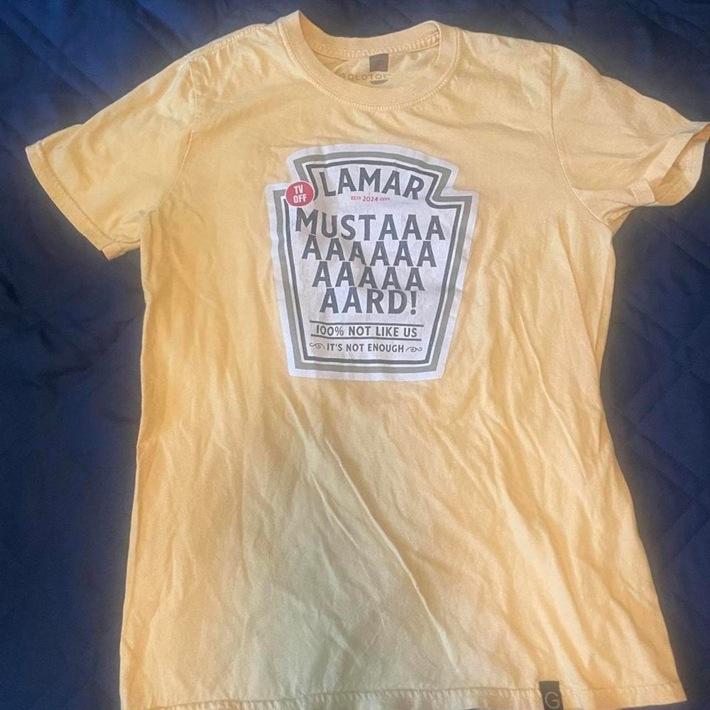 Yellow Lamar Mustard tee with graphic featuring 'LAMAR' and 'MUSTAAA AAAAA AA